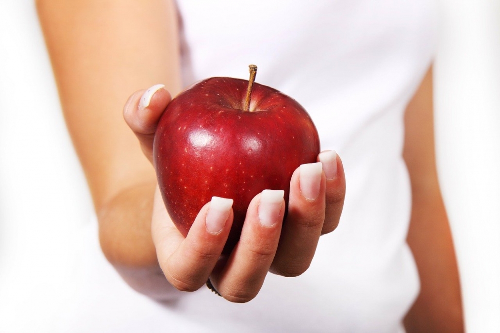 woman with apple for a healthy diet after a binge